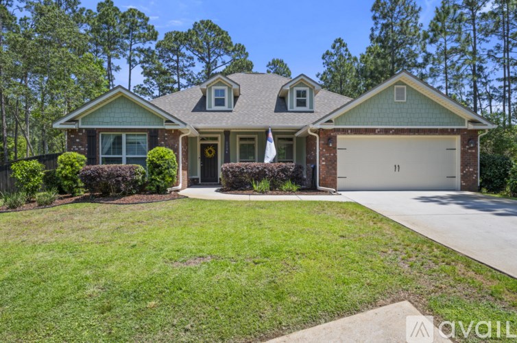 A house with a green roof and a white garage door.