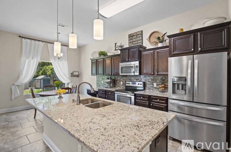 A kitchen with granite countertops and stainless steel appliances.