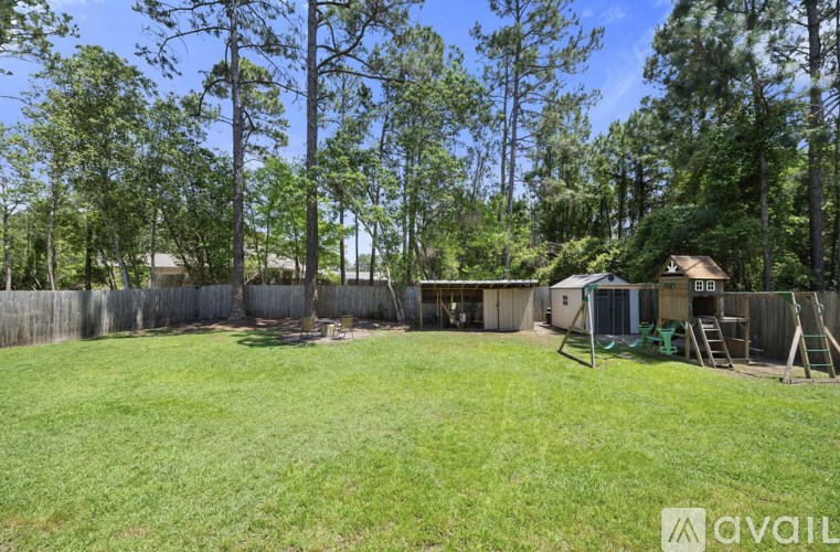 A backyard with a wooden fence and a shed.