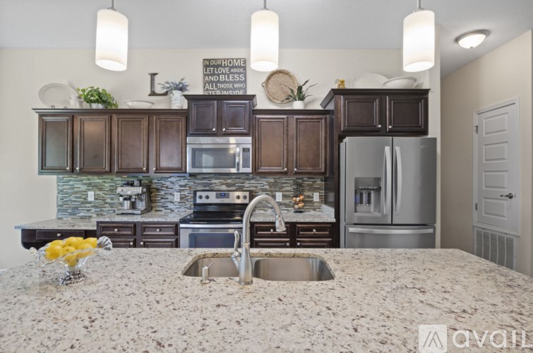 A kitchen with a granite countertop and a refrigerator.