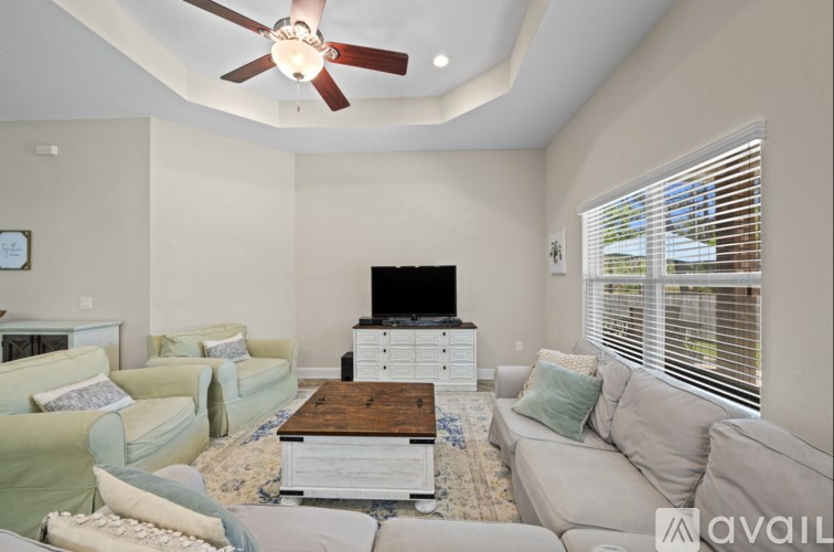 A living room with a television, two couches, and a coffee table.