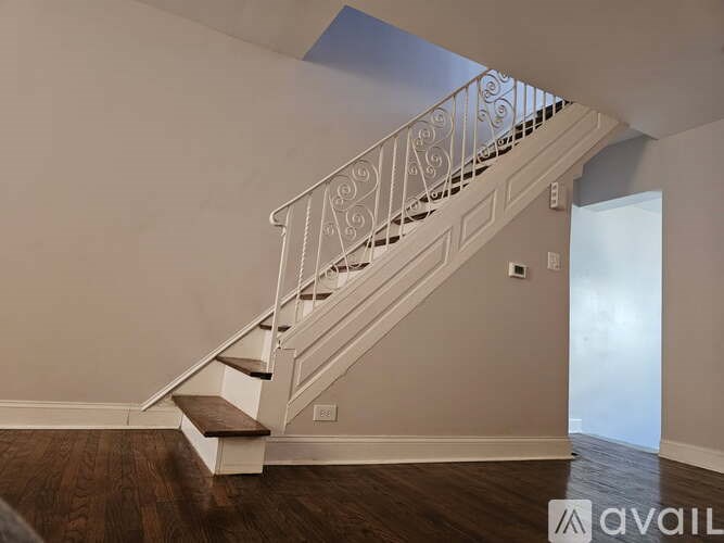 A staircase with a metal railing and wooden steps.