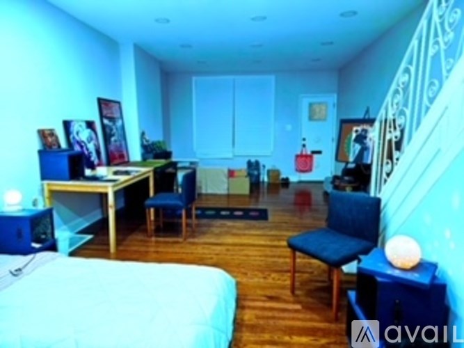 A bedroom with a bed, desk, and chair.