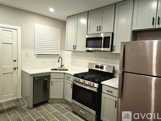 A kitchen with a stove, oven, and refrigerator.