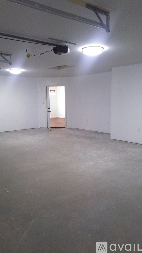 A room with a door and a light on the ceiling.