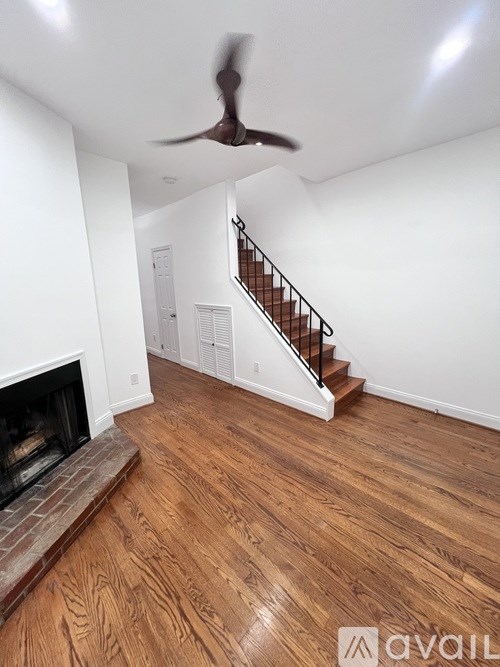 A room with a fireplace and wooden floors.