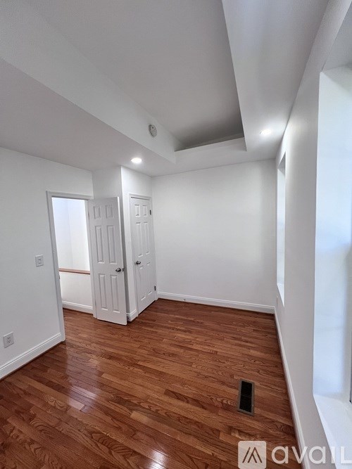 A room with wooden floors and white walls.
