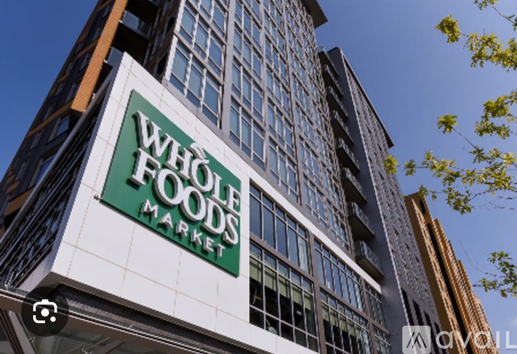 A tall building with a sign that says "Whole Foods Market".