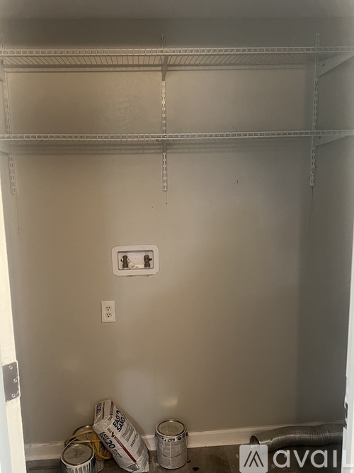 A wall with a switch and a socket on it.