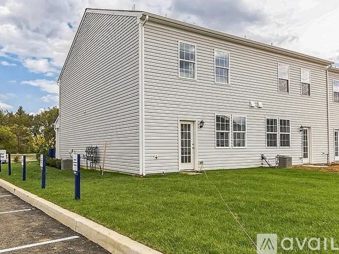 A large white building with a striped exterior and a row of windows.