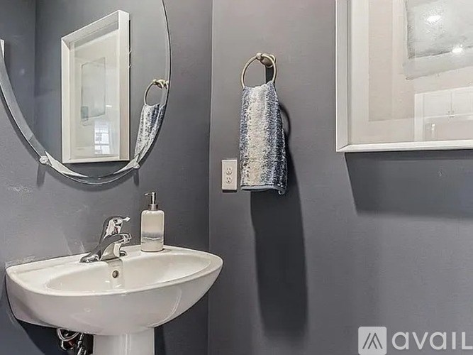 A bathroom with a white sink and a mirror.
