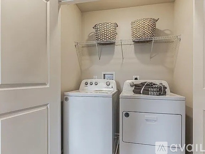 A small laundry room with a washer and dryer.