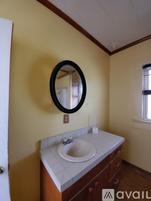 A bathroom with a sink and a mirror.