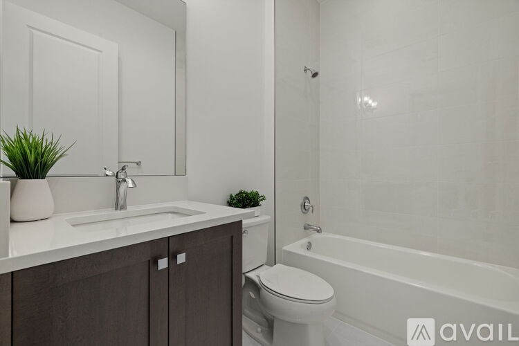 A bathroom with a white sink and a white toilet.
