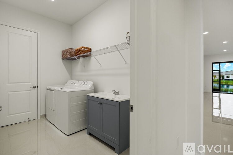 A white bathroom with a towel rack and a window.