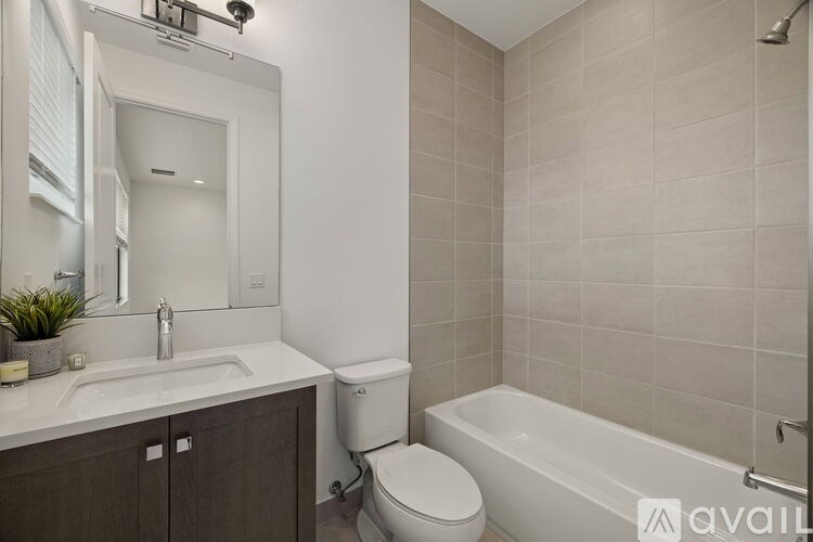 A bathroom with a white sink, toilet, and bathtub.