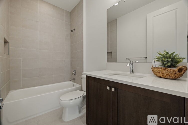A bathroom with a white tub, toilet, and sink.