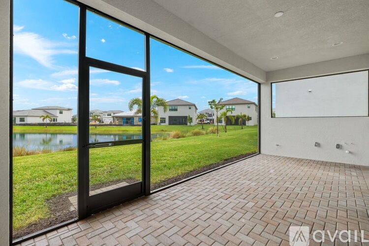 A room with a large glass door leading to a brick patio.