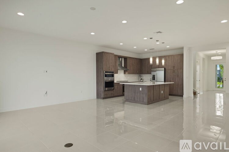 A modern kitchen with a central island and a dining area.