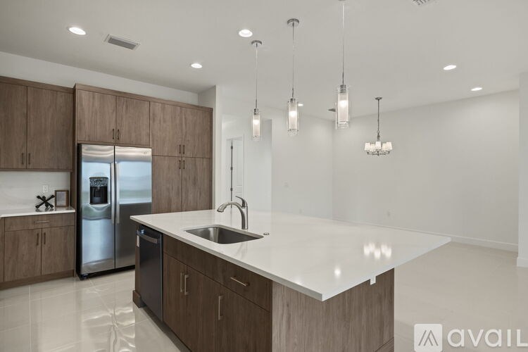 A modern kitchen with a white countertop and wooden cabinets.