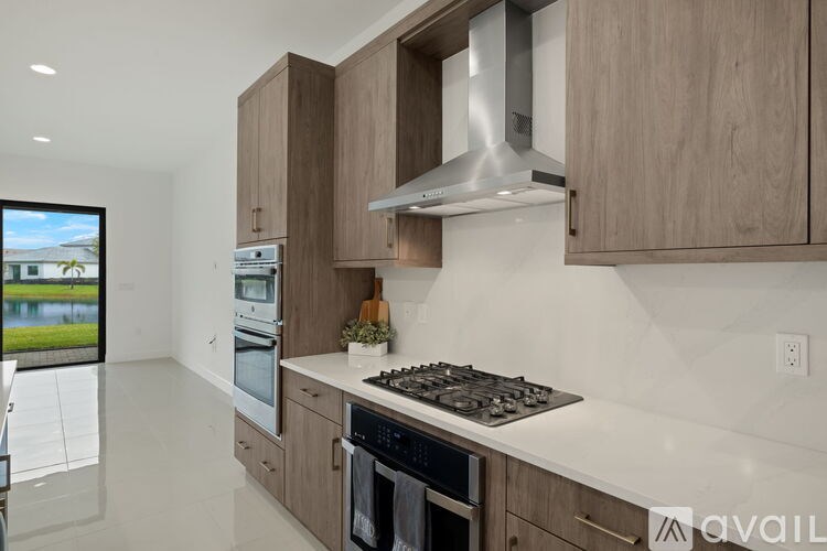 A modern kitchen with wooden cabinets and stainless steel appliances.
