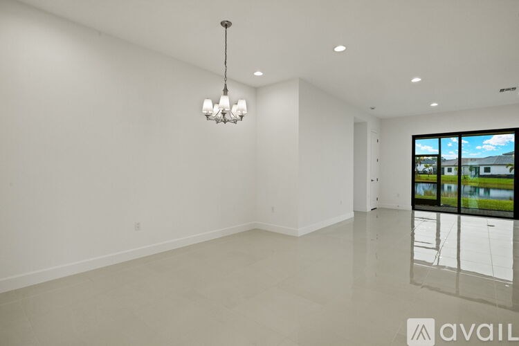 A large empty room with a chandelier hanging from the ceiling.