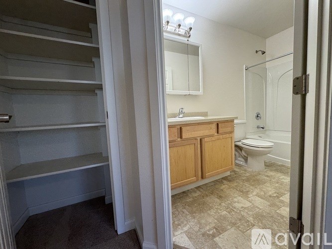 A bathroom with a walk-in shower, toilet, and sink.