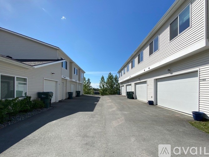 A sunny day at a residential area with houses and driveways.