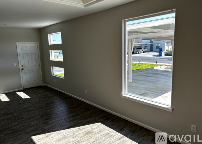 A room with a large window and a door.