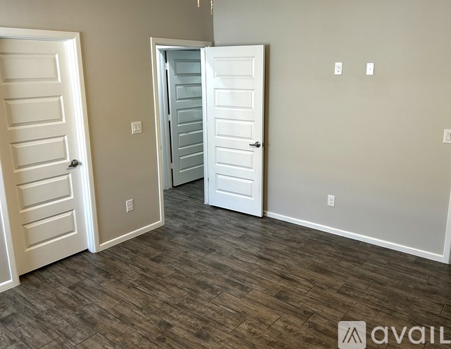 A room with two doors, one of which is open.