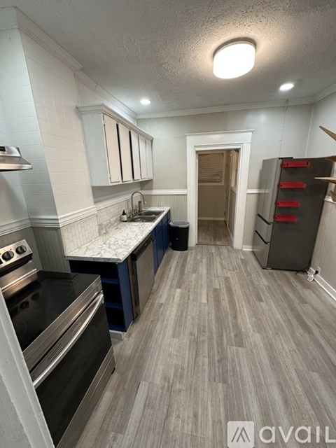A kitchen with a stove top oven and a sink.