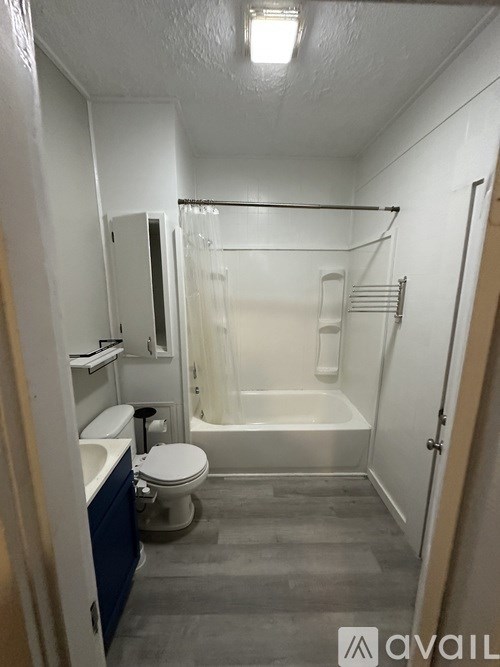A small bathroom with a toilet, sink, and bathtub.