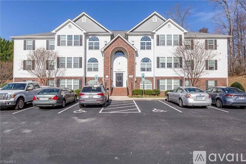 A large building with a parking lot in front of it.