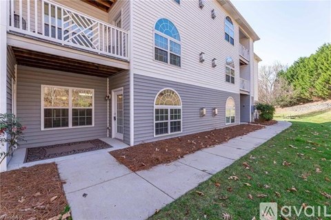 A two-story house with a balcony and a front door.