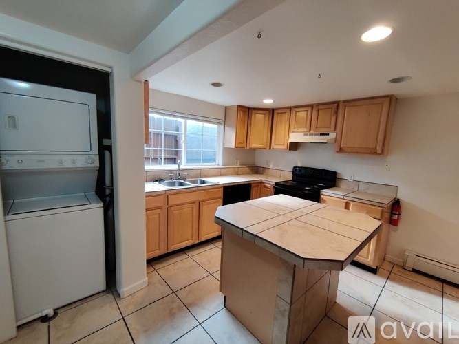 A kitchen with wooden cabinets and a white fridge.