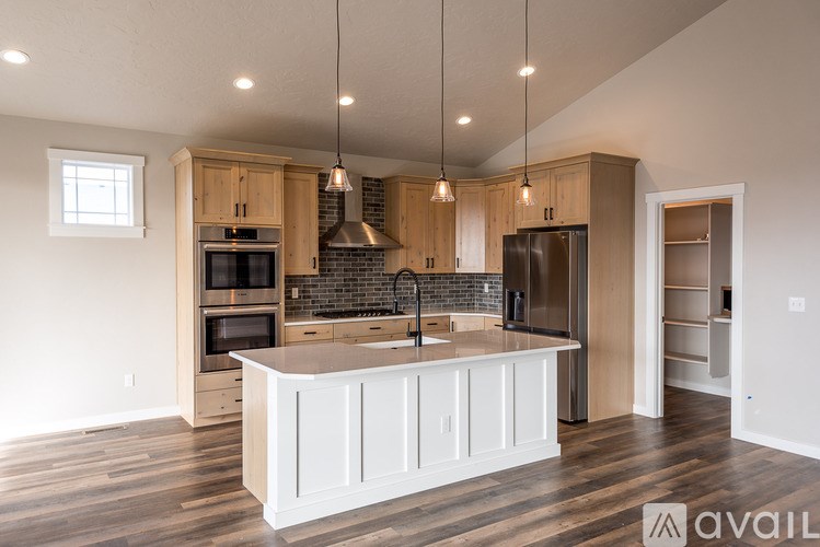 A kitchen with a white island in the middle of it.