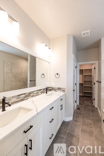 A bathroom with two sinks and a mirror.