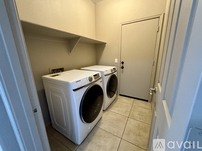 A small laundry room with a washer and dryer.