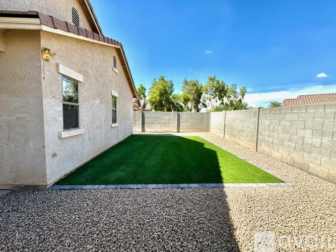 A house with a green lawn in front.
