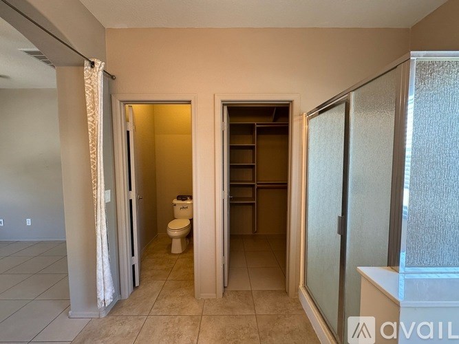 A bathroom with a toilet, sink, and shower.
