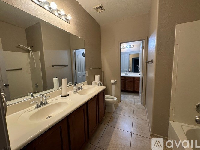 A bathroom with two sinks and a toilet.