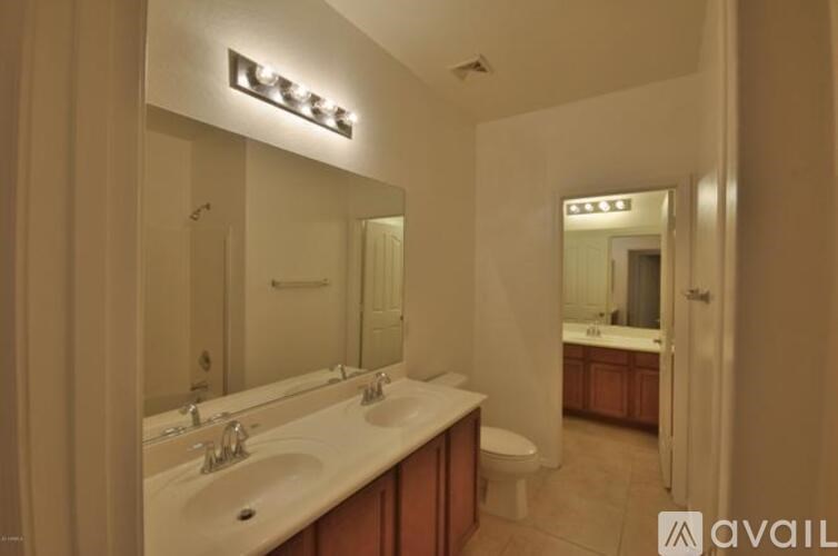 A bathroom with a white sink and a mirror above it.