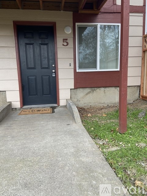 A black door with a number 5 on it.