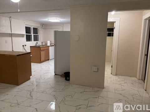 A kitchen area with a counter and a fridge.