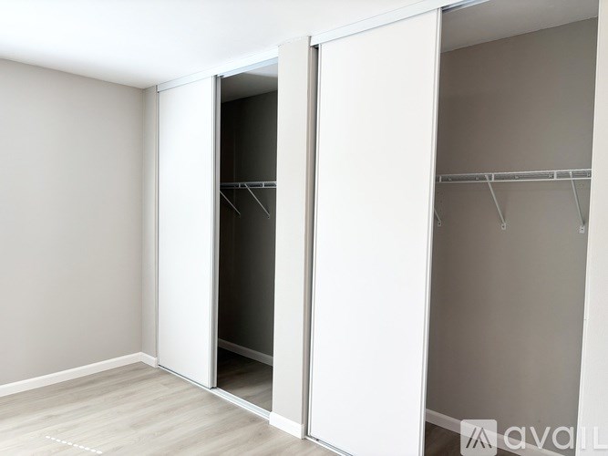 A room with a white door and a white wall.