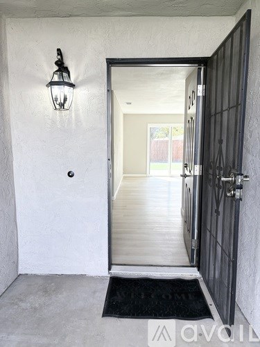 A white door with a black mat in front of it.