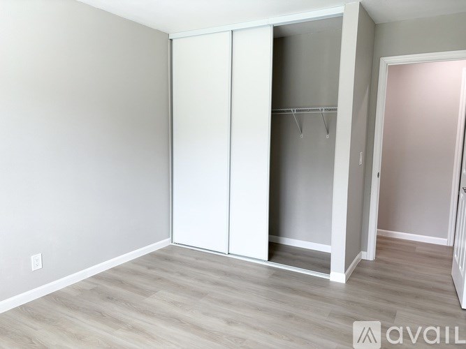 A room with a white closet and a grey floor.