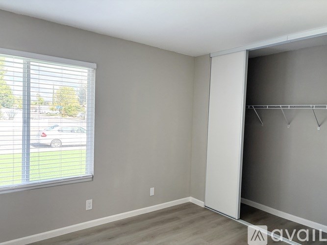 A room with a grey wall and a white closet.