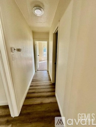 A hallway with a door at the end.