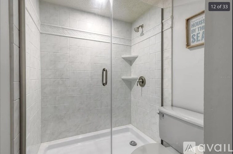 A white bathroom with a shower and a bathtub.